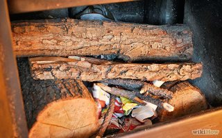 Fire laid with paper lighters under a frame of wood